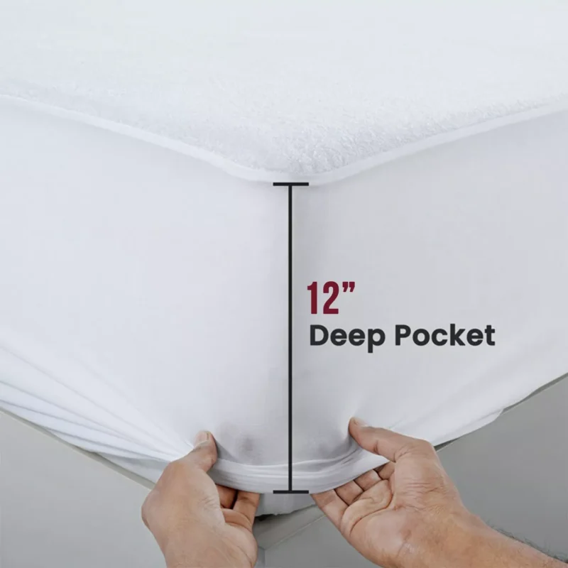 Hands stretching a mattress protector with a 12-inch deep pocket.