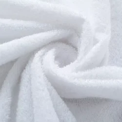 Close-up of white terry towel fabric in a spiral pattern.