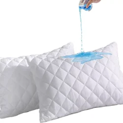 Two white quilted pillows with blue liquid being poured on them.