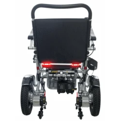 Rear view of a folding electric wheelchair showing wheels and frame.