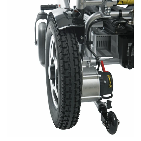 Close-up of rear wheel and motor of a folding electric wheelchair.