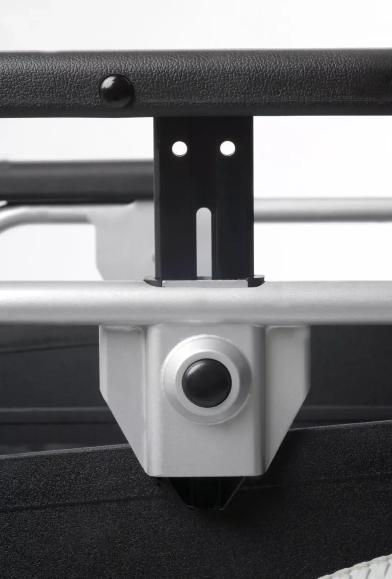 Close-up of the adjustable armrest mechanism on a wheelchair.