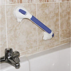 Suction grab bar with blue handle attached to a tiled bathroom wall.