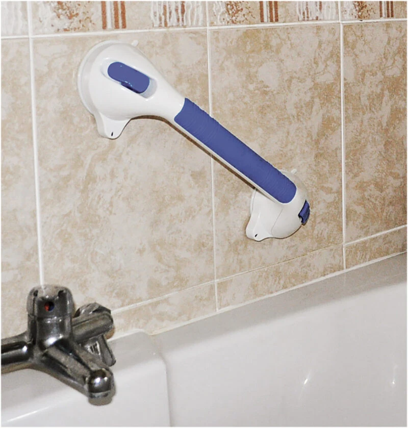 Suction grab bar with blue handle attached to a tiled bathroom wall.