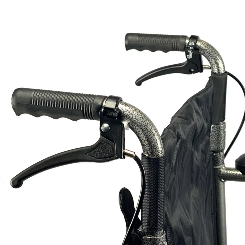 Close-up of the attendant brakes on a folding transit wheelchair.