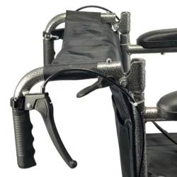 Close-up view of the attendant brake on a folding transit wheelchair.