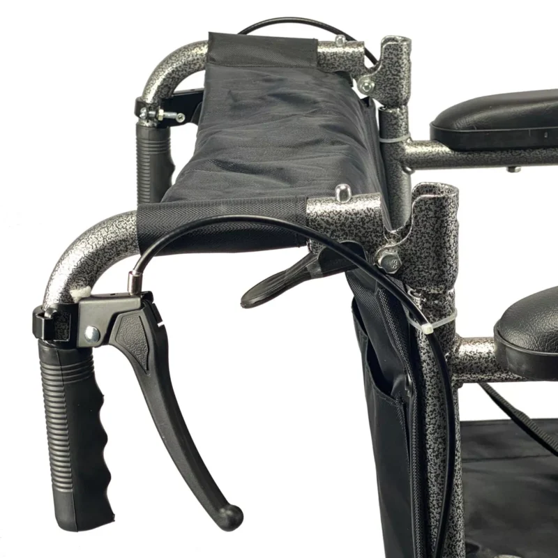 Close-up view of the attendant brake on a folding transit wheelchair.
