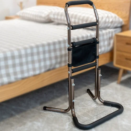 Mobility standing aid positioned beside a bed.