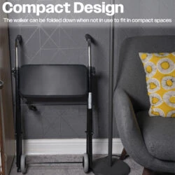 Foldable walker with seat folded against a wall in a living room.