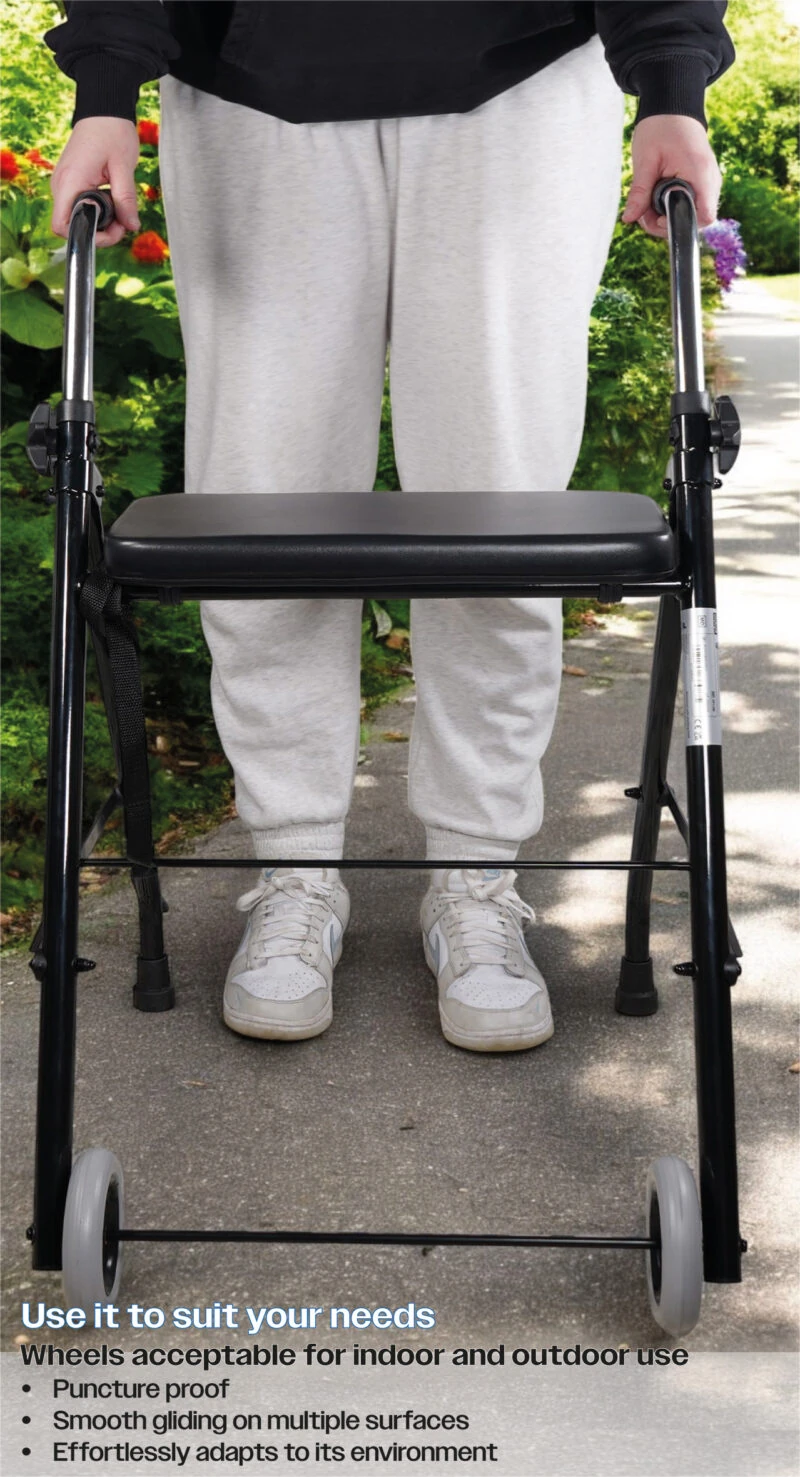 Person using a foldable walker with a padded seat outdoors.