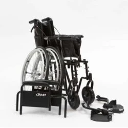 Black bariatric wheelchair with detached footrests and armrest.