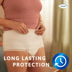 Person wearing Tena Pants Bariatric in a room with text 'Long Lasting Protection'.
