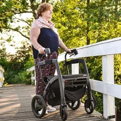 Person using Rollz Motion Rhythm Rollator on a wooden bridge.