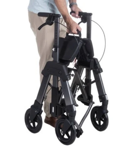 Person holding a folded Bariatric EZ Fold N Go Rollator.