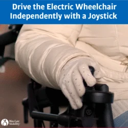 Close-up of a gloved hand using a joystick on an electric wheelchair.