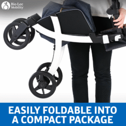 Person holding a folded Rollz Flex Shopper rollator.
