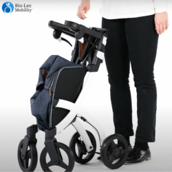 Folded Rollz Flex Shopper rollator with a shopping bag, next to a person.