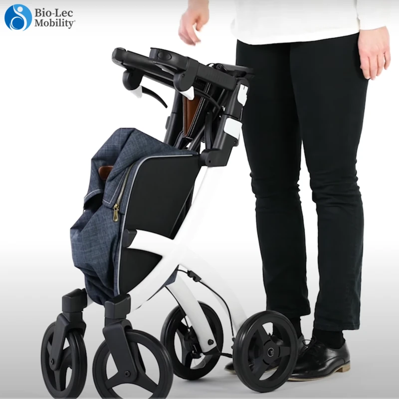 Folded Rollz Flex Shopper rollator with a shopping bag, next to a person.