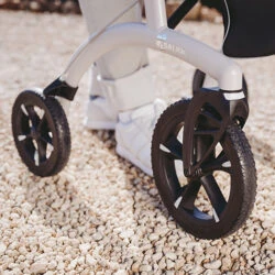 Close-up of Saljol Allround Crossover Rollator wheels on gravel.