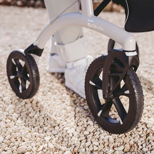 Close-up of Saljol Allround Crossover Rollator wheels on gravel.