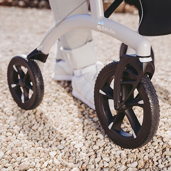Close-up of Saljol Allround Crossover Rollator wheels on gravel.