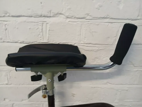 Close-up of forearm support handle with padded armrest and adjustable grip.