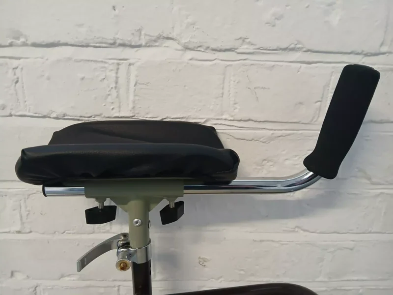Close-up of forearm support handle with padded armrest and adjustable grip.