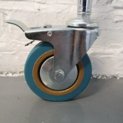 Close-up of a blue caster wheel with a metal bracket on a trolley.