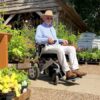 Person using the Freedom Chair A06L electric wheelchair outdoors.