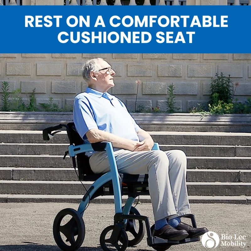 Man seated on a Rollator Wheelchair in front of steps.
