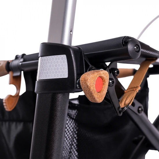 Close-up of ergonomic cork armrest and part of the frame of the Saljol Allround Crossover Rollator.
