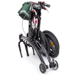Folded Trionic 14er Rollator Walker with large wheels and green bag.