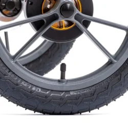 Close-up of a large pneumatic wheel with detailed tread.