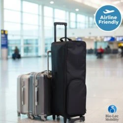 Black carry bag with wheels next to suitcases in an airport.