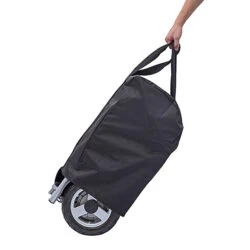 Wheelchair partially covered in a black travel bag with a visible wheel.