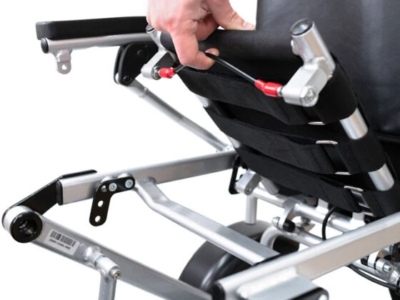 Close-up of a hand adjusting the wheelbase of the Freedom Scooter S1.