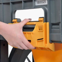 Hand attaching a yellow commode pan to a gray frame.