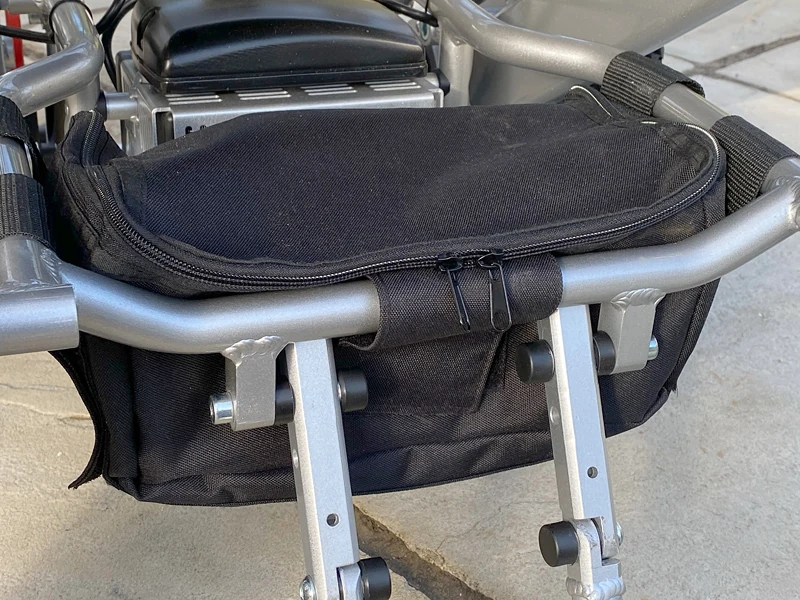 Close-up of the Freedom Chair DE08L's black storage bag attached to the frame.
