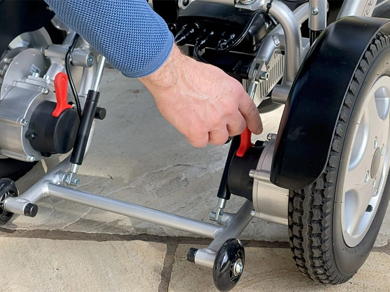 Hand adjusting the wheel mechanism of the Freedom Chair A08.