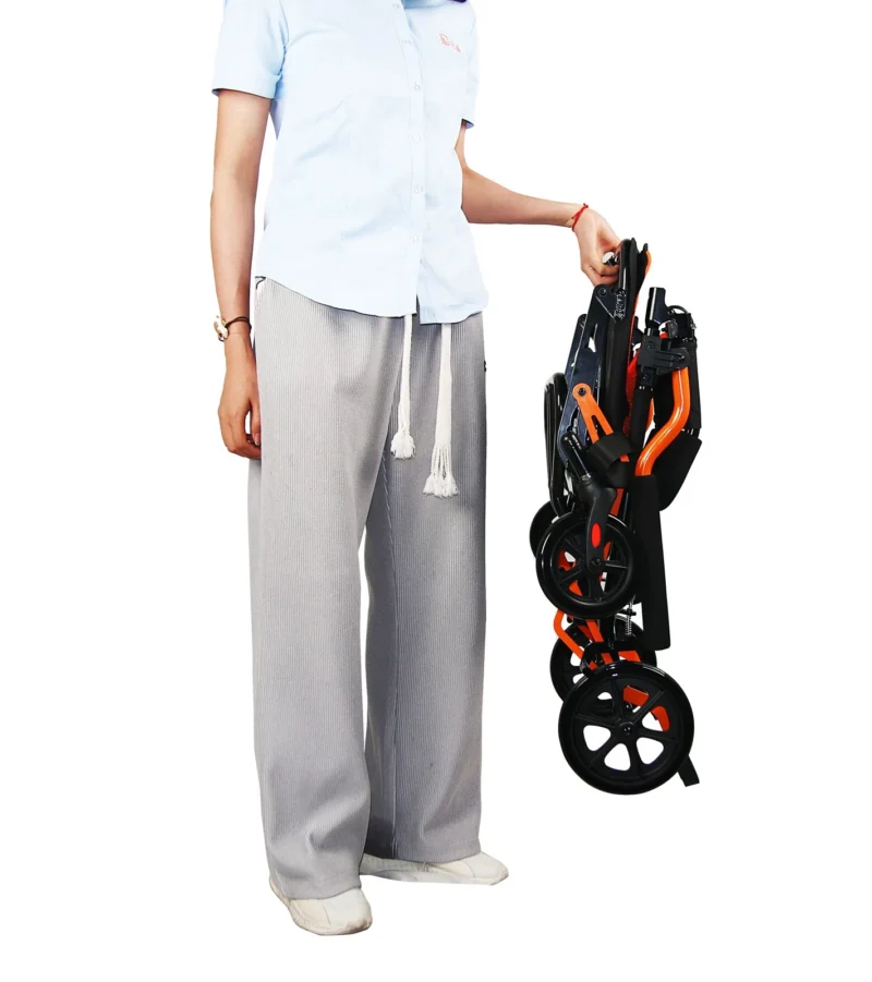 Person holding a folded lightweight travel wheelchair.