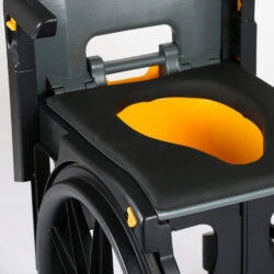 Close-up of a wheelable commode with a small aperture seat.