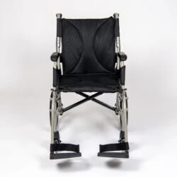 Front view of a black lightweight transit wheelchair with footrests.