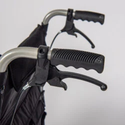 Close-up of wheelchair handles with attendant brakes.