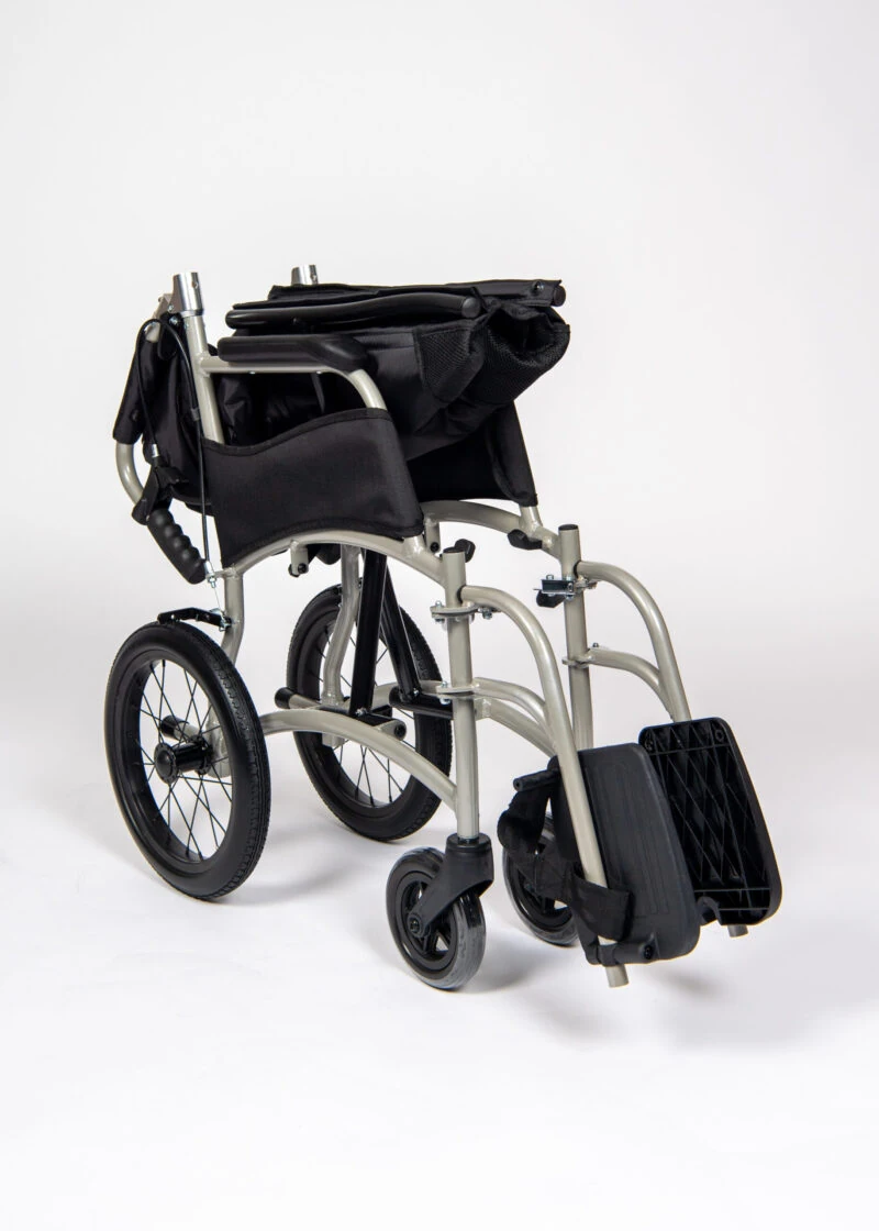 Folded lightweight transit wheelchair with black seat and silver frame.