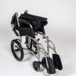 Folded lightweight transit wheelchair with compact design.