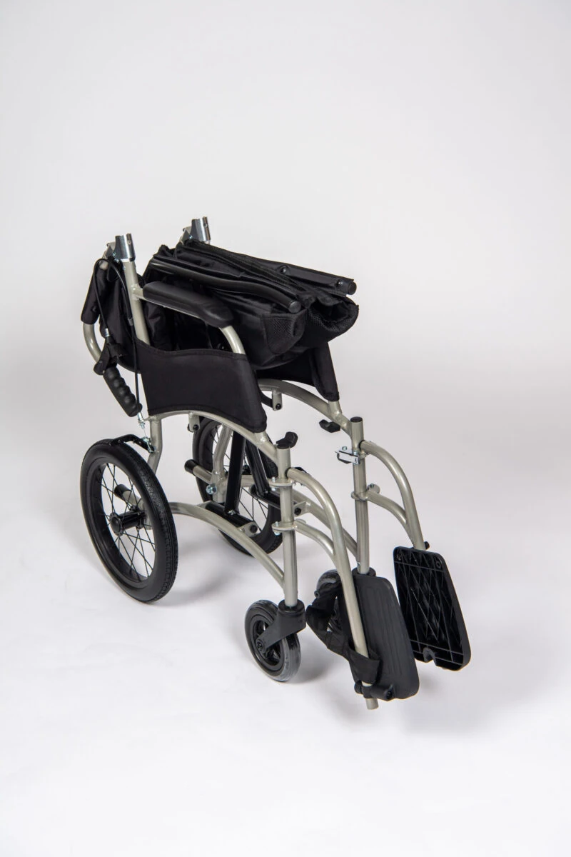 Folded lightweight transit wheelchair with compact design.
