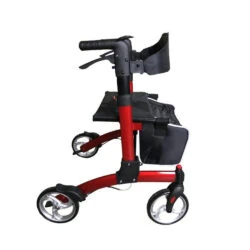Side view of a red fold down rollator with a seat and shopping bag.