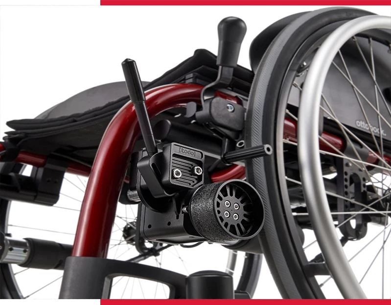 Close-up of electric wheelchair's rear wheel and motor mechanism.