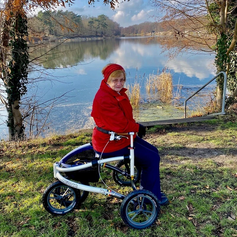Person sitting on a Trionic Veloped Tour 14er near a lake.