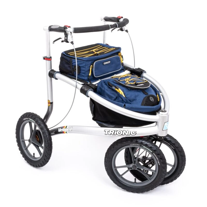 Trionic Veloped Trek 14er rollator with blue storage bags and large wheels.
